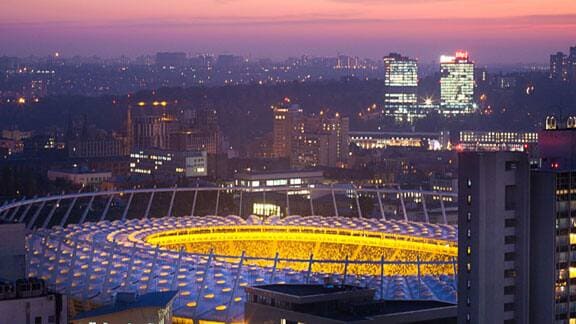 Aerial view of a stadium amidst a city during the night