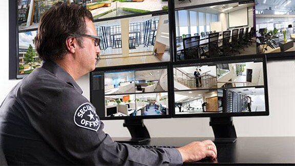 A security personnel monitoring the cctv camera footages
