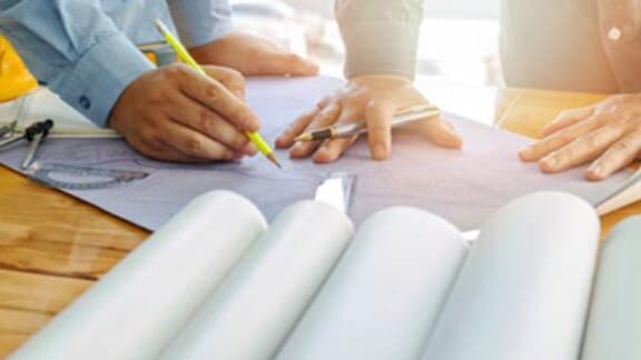 hands-of-architects-working-on-floor-plan
