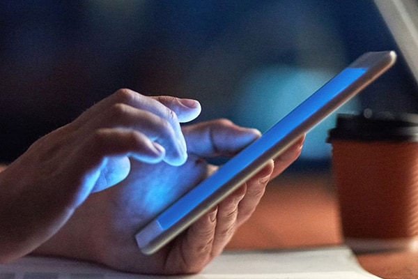 Closeup-person-handholding-touchpad